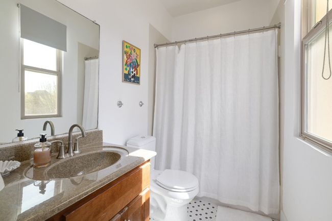 Full bath featuring vanity, a shower with shower curtain, and toilet | Image 20