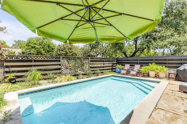 View of pool with a patio area and a grill | Image 36