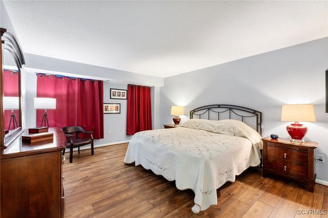 Bedroom with hardwood / wood-style floors and baseboards | Image 17