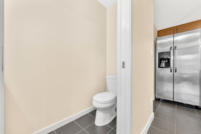Bathroom featuring tile patterned flooring, toilet, and baseboards | Image 18