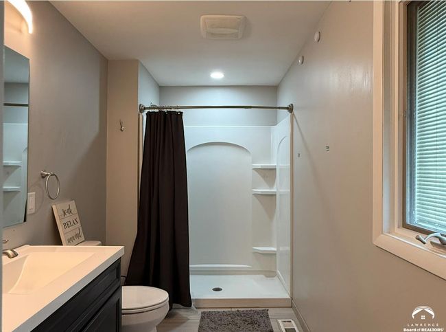 2021 remodeled bathroom dedicated to primary bedroom has new window w/ 2 panes & internal blinds. | Image 7