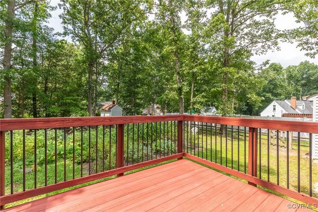 Wooden deck with a storage shed and a fenced backyard | Image 42