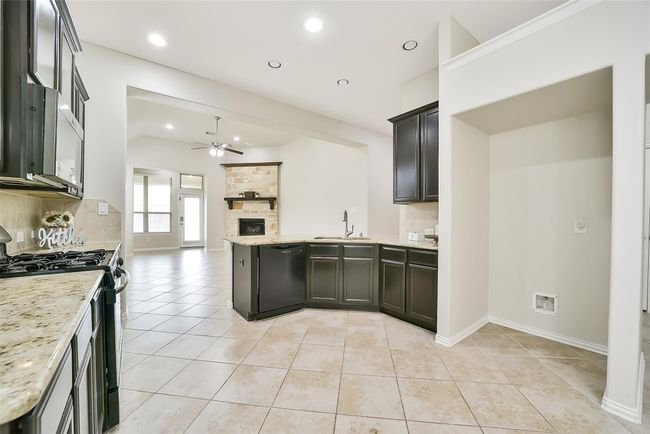 Let's head back through the kitchen and take a closer look at the family area and owner's suite. | Image 13