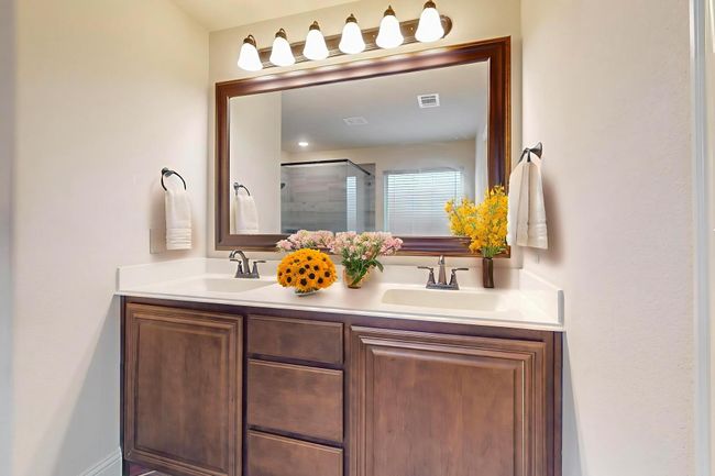 Bathroom with double vanity and a shower stall | Image 10