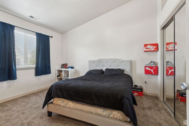 Carpeted bedroom featuring lofted ceiling, baseboards, and a closet | Image 19