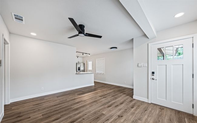 Foyer with ceiling fan, wood finished floors, plenty of natural light, recessed lighting, and rail lighting | Image 6