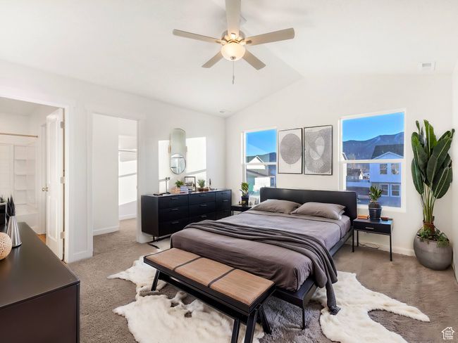 Bedroom with light colored carpet, lofted ceiling, and a ceiling fan | Image 5