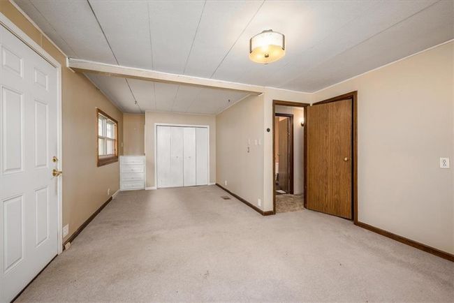 Unfurnished bedroom featuring light carpet, a closet, and baseboards | Image 22