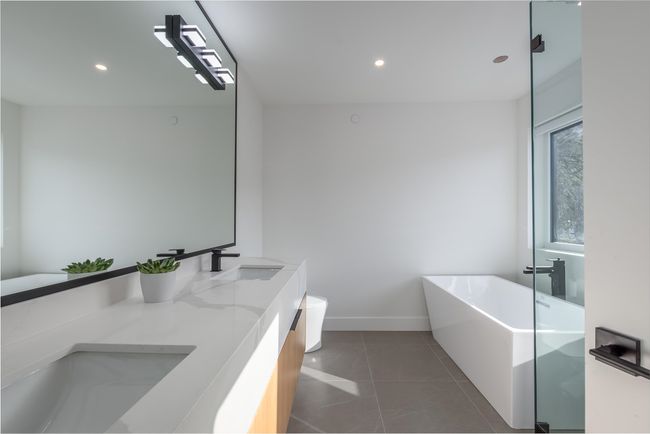 Bathroom featuring a freestanding bath, tile patterned floors, recessed lighting, and a sink | Image 20