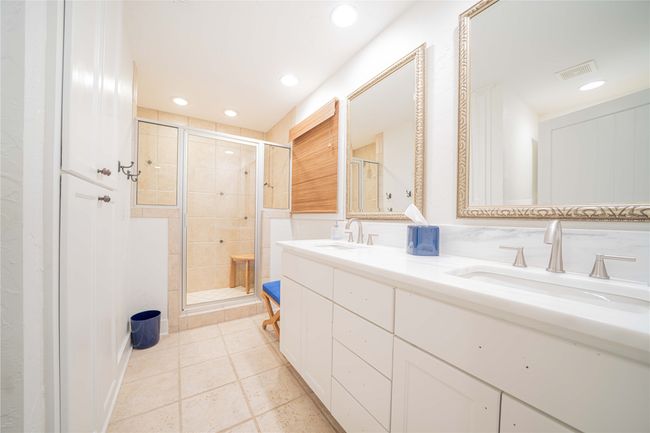 Full bath with a stall shower, double vanity, recessed lighting, and tile patterned floors | Image 31