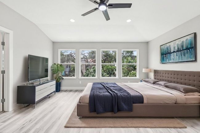 Bedroom featuring multiple windows, wood finished floors, baseboards, vaulted ceiling, and recessed lighting | Image 5