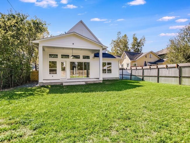 Rear view of house with a patio area and a fenced backyard | Image 29