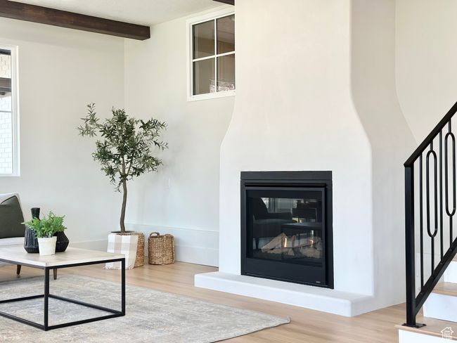 Detailed view of wood finished floors and a glass covered fireplace | Image 14