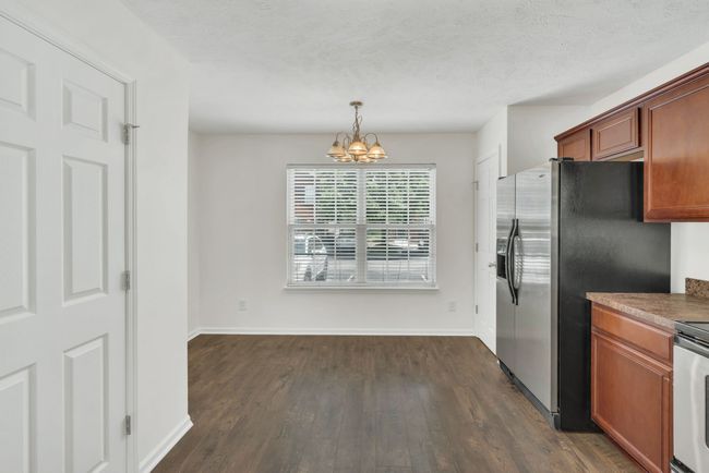 Beautiful LVP flooring throughout the entire kitchen (and den). The doors to the left open into the laundry area | Image 9
