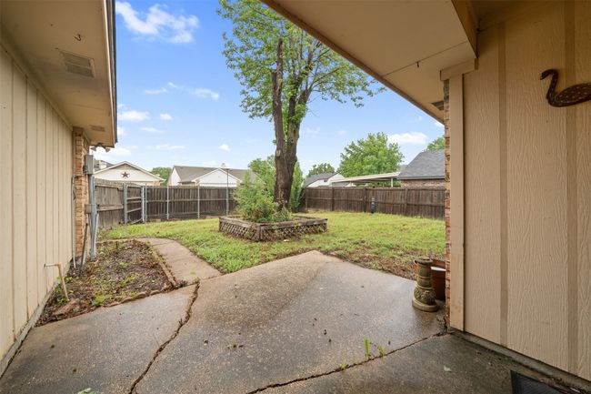 View of yard featuring a fenced backyard and a patio area | Image 21