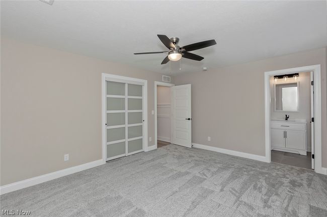 Unfurnished bedroom with a closet, carpet, and ceiling fan | Image 48