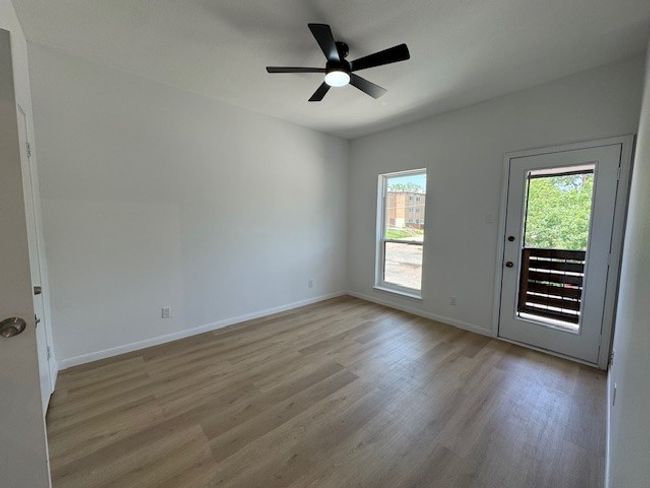 Empty room featuring light wood finished floors and ceiling fan | Image 4