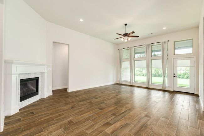 family area with floor-to-ceiling windows that looks onto the screened covered patio and the waterfront exceeded all of your expectations. | Image 25