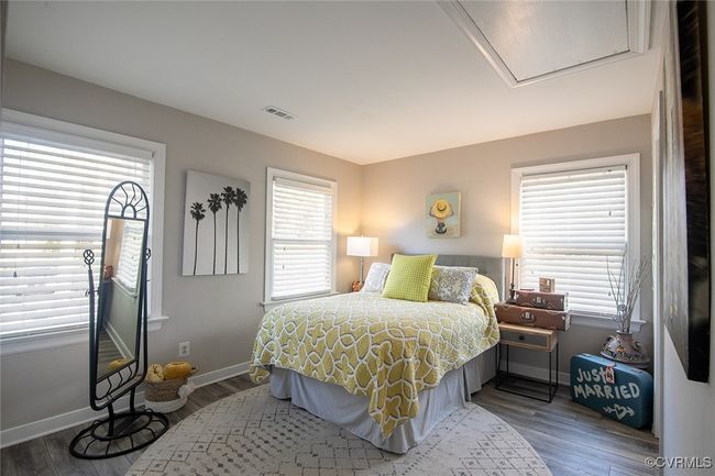Bedroom with visible vents, baseboards, and wood finished floors | Image 18