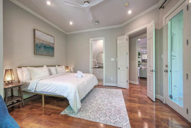 Guest room/office off the living room has exterior door to backyard patio | Image 18