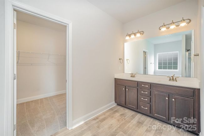 Primary ensuite bathroom with dual vanities, and huge walk-in closet. | Image 18