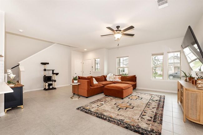 Living area featuring ceiling fan and baseboards | Image 10