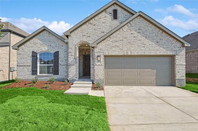 View of front of house featuring a garage and a front lawn | Image 1