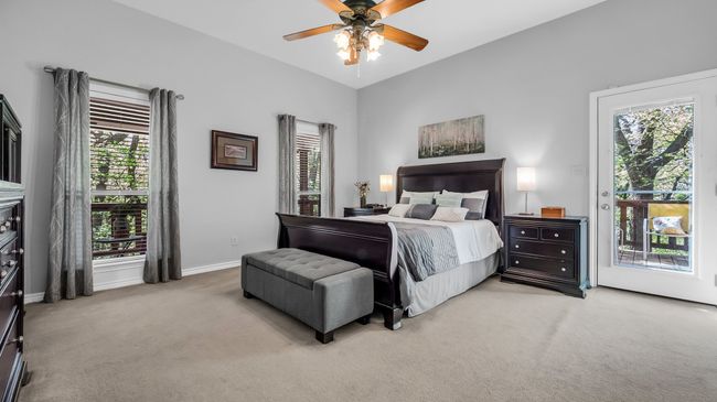 Bedroom with access to exterior, light colored carpet, baseboards, and ceiling fan | Image 17