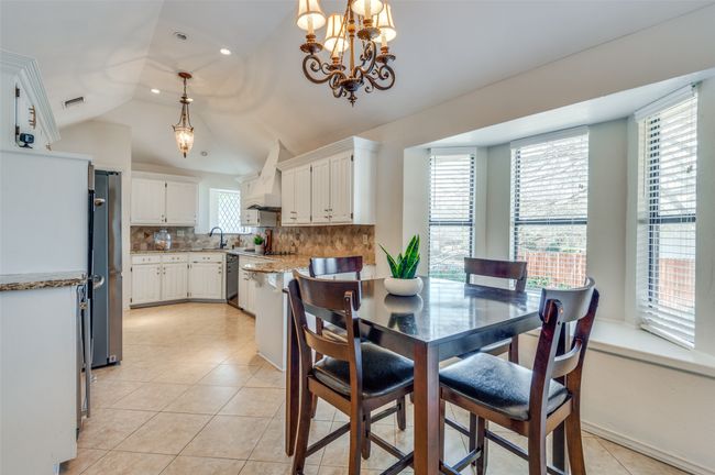 Dining area featuring recessed lighting, vaulted ceiling, a notable chandelier, and light tile patterned flooring | Image 15