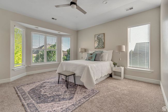 Bedroom featuring carpet, multiple windows, and ceiling fan | Image 15