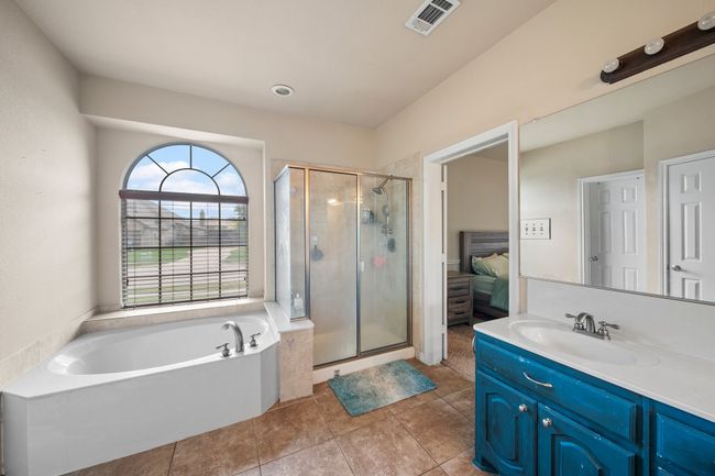 Ensuite bathroom with vanity, a stall shower, visible vents, and a bath | Image 21