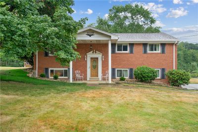 Stunning brick home with pillars welcoming your guests. | Image 1