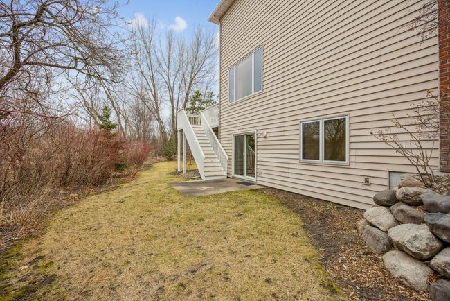 East side of home with small patio off of the walkout. | Image 31