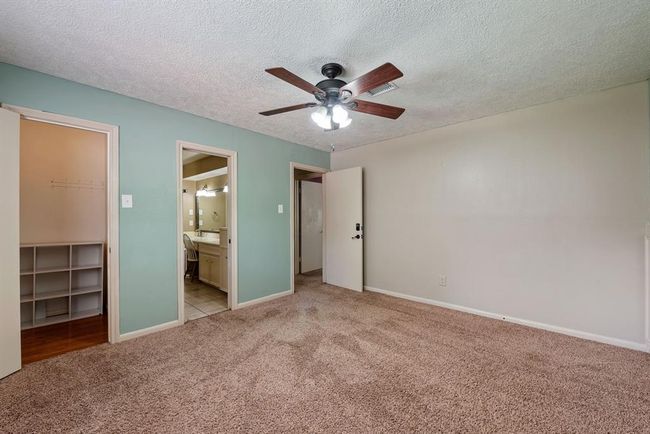 On the other side of the bathroom is a bedroom with soft green walls. | Image 25
