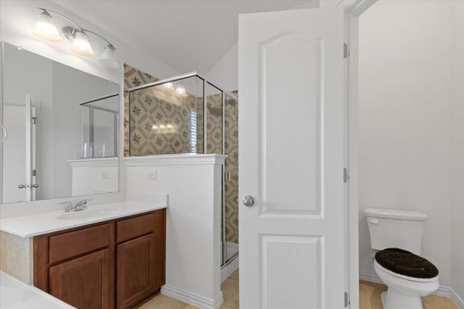 Bathroom with vanity, tile patterned flooring, and a stall shower | Image 18