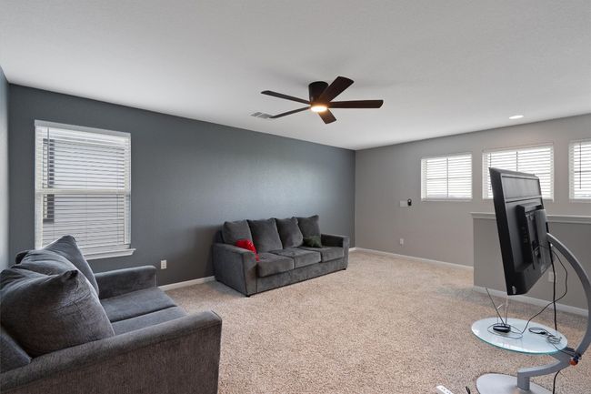 Living room featuring ceiling fan and light colored carpet | Image 19