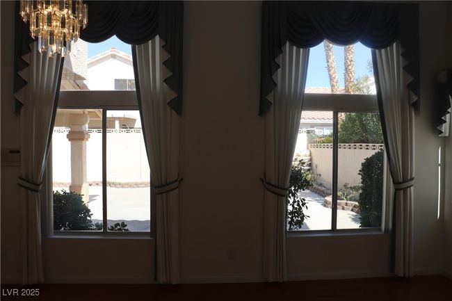 Detailed view of a chandelier and baseboards | Image 35
