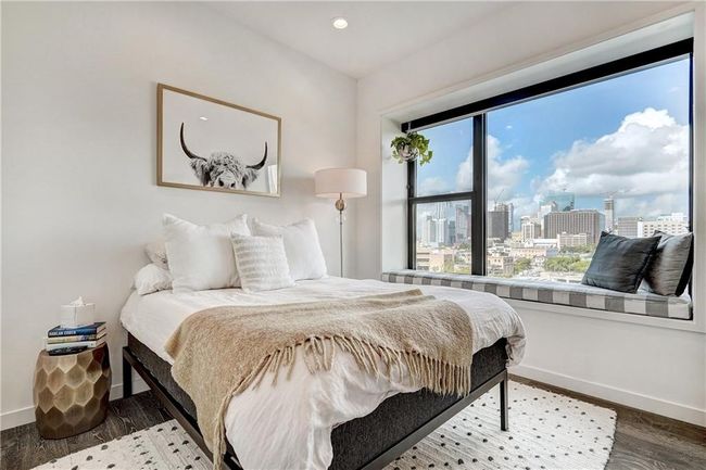 Private guest bedroom with built in window seat is perfect for admiring the gorgeous downtown landscape. | Image 21