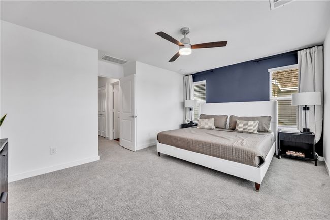 Carpeted bedroom with ceiling fan, visible vents, and baseboards | Image 11