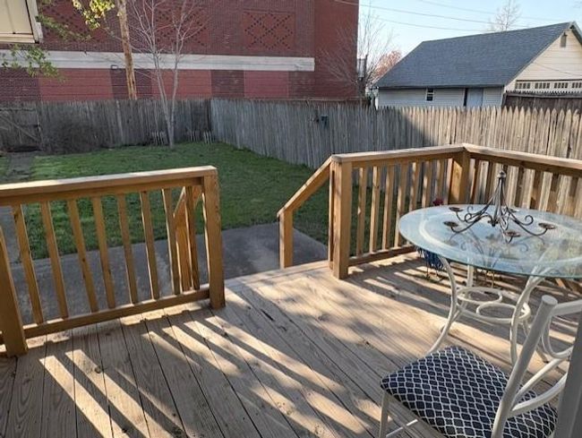 Wooden terrace featuring a lawn and a fenced backyard | Image 27
