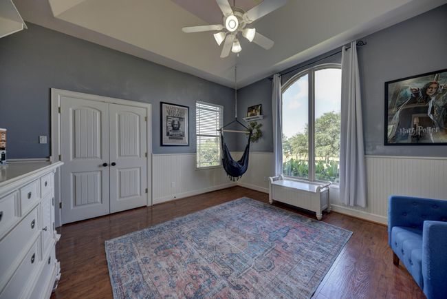 Bright and inviting Guest room with large arched window offering plenty of natural light. | Image 19