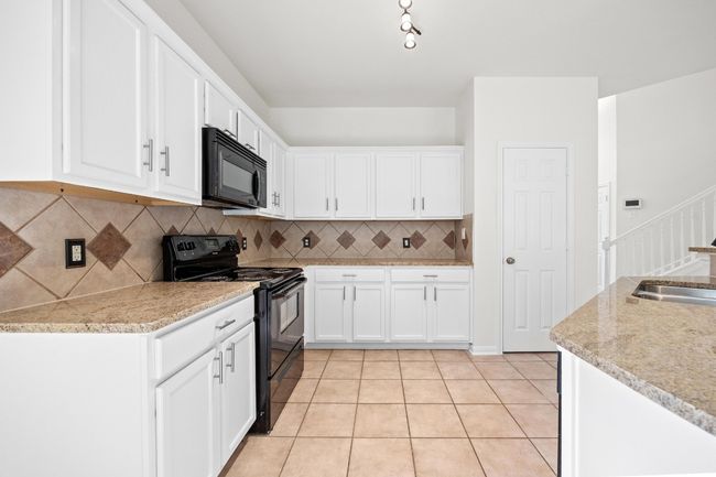 The kitchen opens to the family room and makes for great entertaining. | Image 15