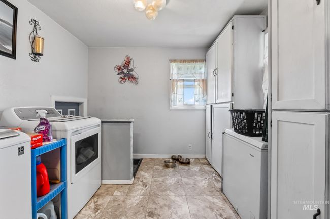 Laundry area featuring separate washer and dryer and cabinet space | Image 18