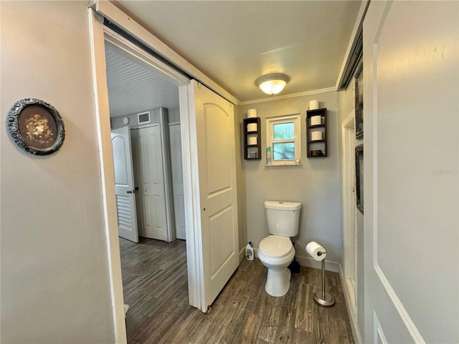 Primary full bathroom with stand up shower and barn door to cover laundry closet with stackable washer/dryer | Image 20
