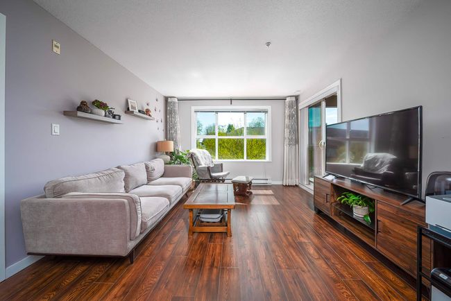 Living area with baseboards and wood finished floors | Image 12