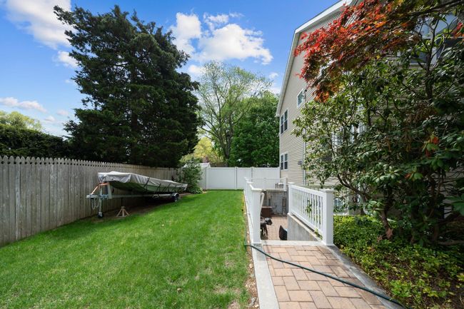 View of yard featuring a storage unit, an outbuilding, and outdoor dining area | Image 41