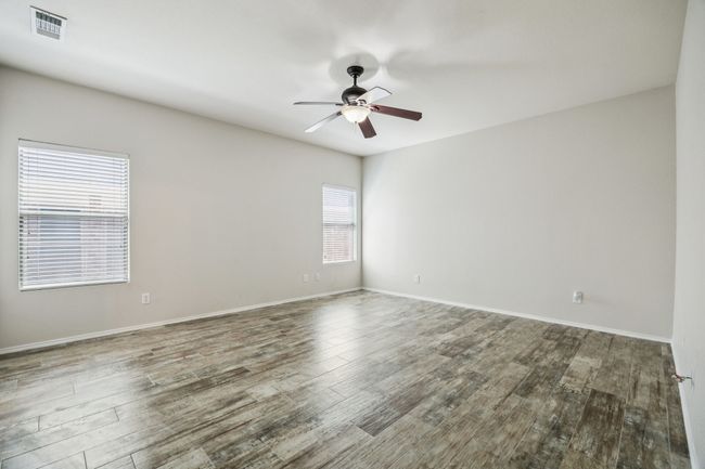 Unfurnished room with ceiling fan and wood finished floors | Image 14
