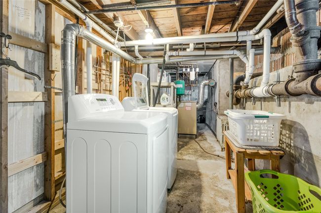 Laundry room with a heating unit, laundry area, and independent washer and dryer | Image 31