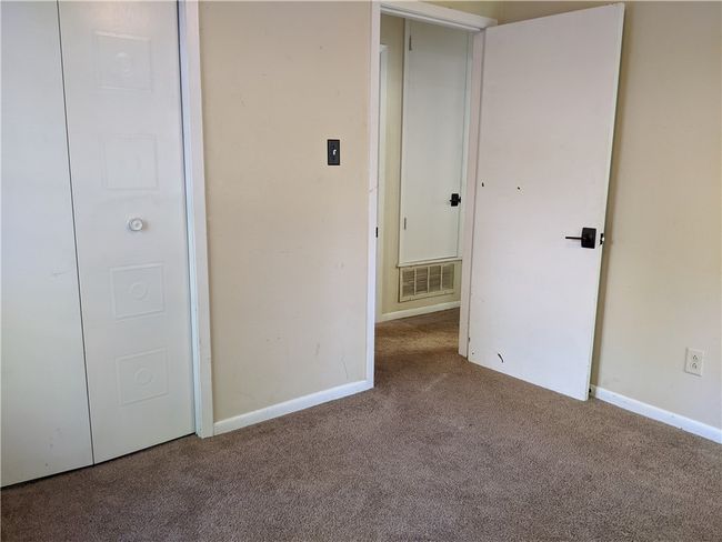 Unfurnished bedroom with carpet flooring and baseboards | Image 5