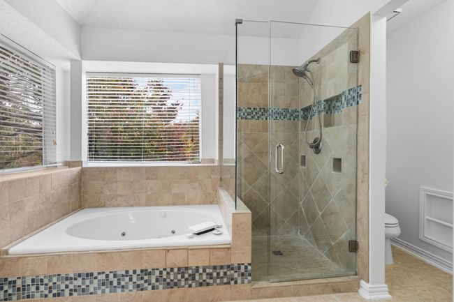The primary bath has a updated jetted tub and shower. | Image 28
